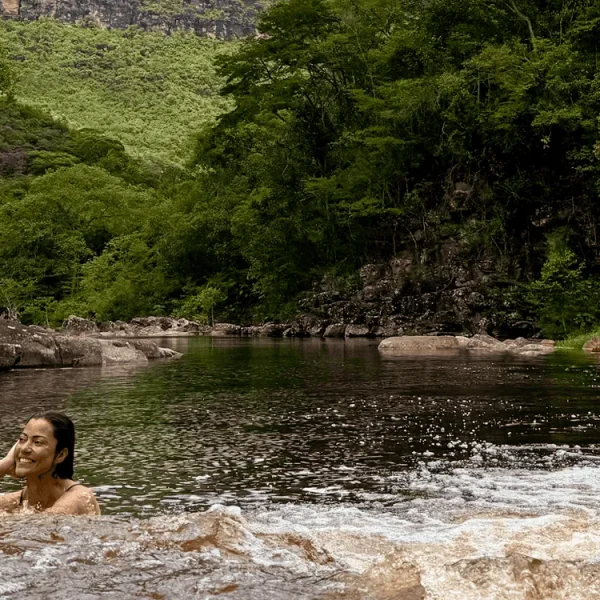 Moça relaxando no Poço da Árvore, em meio as serras do Vale do Pati e águas do rio Funis.